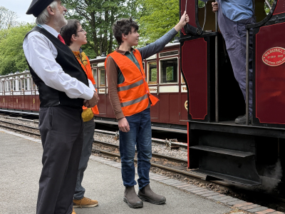 TrackForce volunteers handing over the token at Woody Bay