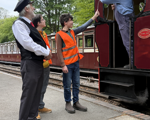 TrackForce volunteers handing over the token at Woody Bay